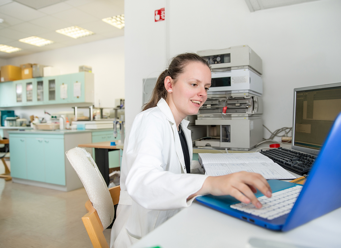 laboratory professional works on her computer in the laboratory