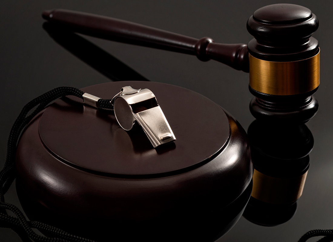 image of whistle and gavel on dark wooden desk