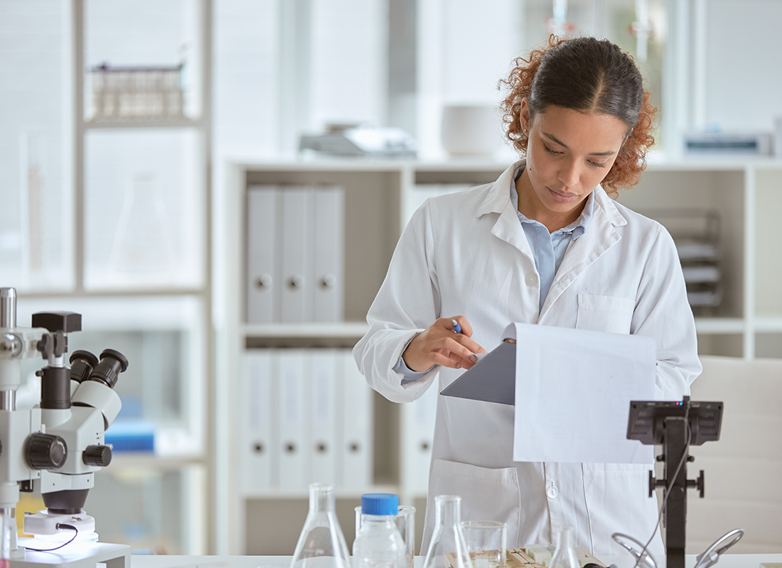 Shot of a young scientist going through paperwork in a lab