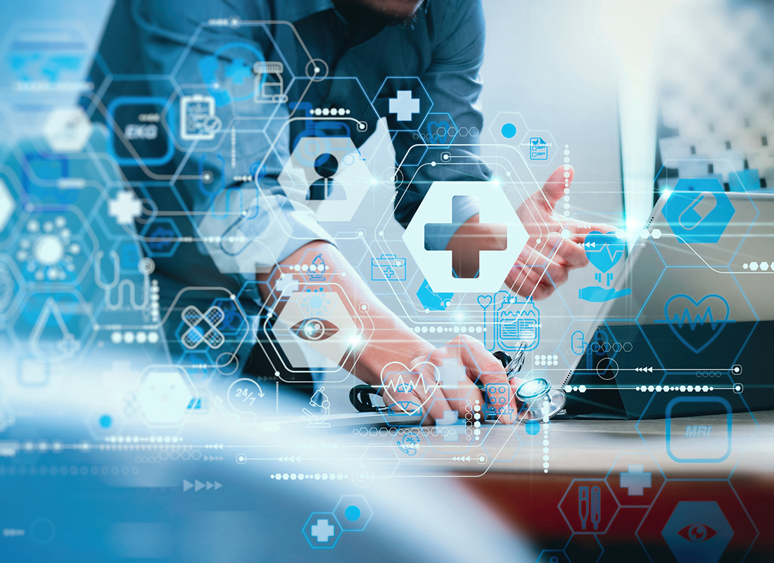 An image of a healthcare professional in business attire working on a laptop, with a graphical overlay of medical icons and lines representing a healthcare network concept.